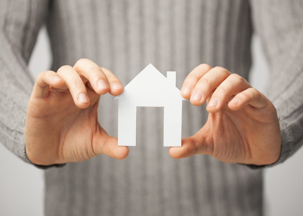 Picture of person holding a cutout of a house